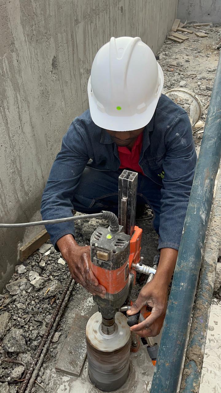 Silver Coring technician performing precision core drilling on a concrete slab